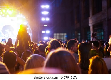 Children Sit Around The Neck At A Street Concert