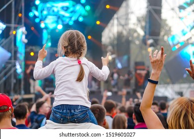 Children Sit Around The Neck At A Street Concert