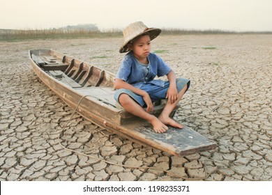 Children Sitting On Boat At Dry River With Sad And Hopeless Face Metaphor Climate Change, Water Crisis And World Environment