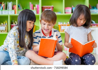 Children Sitting On Floor And Reading Tale Book  In Preschool Library,Kindergarten School Education Concept