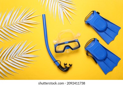 Children Snorkel, diving mask and fins on blue pink pastel background. Travel concept, vacation at sea. minimalistic photo. Flat lay, top view