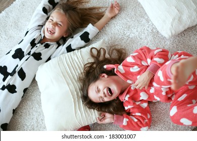 Children in soft warm pajamas playing at home