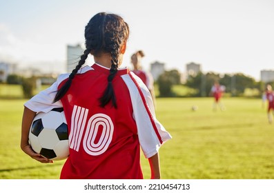 Children, sport and football with a girl soccer player on a field outdoor for fitness, exercise or training. Sports, workout and kids with a female child on grass for health, wellness and recreation - Powered by Shutterstock