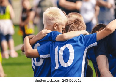 Children in Sports Team. Friends on a Soccer Team. Male Football Players Huddling Together in a Circle Before a Match - Powered by Shutterstock