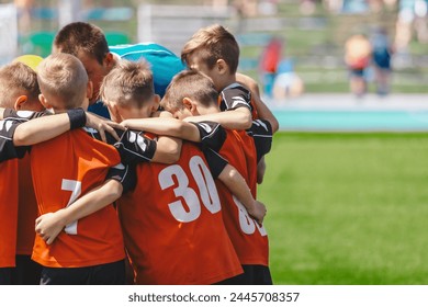 Children in Sports Team. Friends on a Soccer Team. Male Football Players Huddling Together in a Circle Before a Match - Powered by Shutterstock