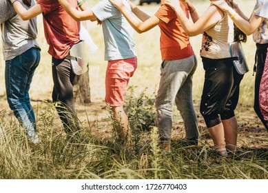 Children stand next to each other and put their hands on the shoulders of a person standing nearby. Team building exercise, team spirit. Strengthening relationships between people in a team.  - Powered by Shutterstock