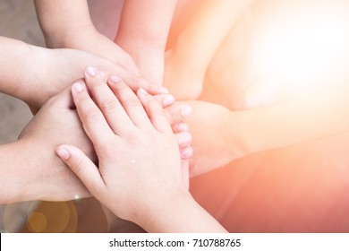 Children Students Hands Stacking Together For Harmonious Concept. Group Of Kids Cohere In Unity. School Kids Hands Volunteer For Public Services And Successful Community Sustainability Goal Concept