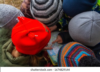 Children study maps of the area. Learning to navigate on the map while Hiking in the forest. - Powered by Shutterstock