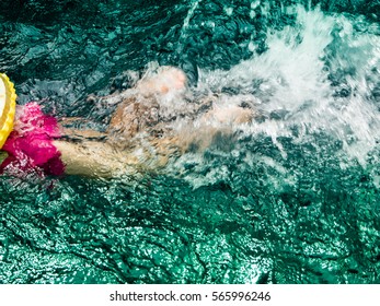 Children are swimming in the pool - Shutterstock ID 565996246
