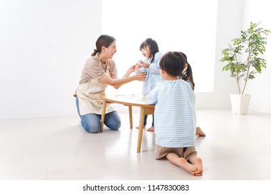 Children and teacher at kindergarten - Shutterstock ID 1147830083