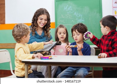 Children and teacher playing with musical instruments in preschool - Powered by Shutterstock