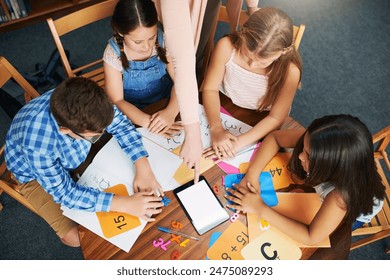 Children, teacher and tablet for education with help, mockup space and blank screen in classroom. People, above and group learning with books, math and point at touchscreen for development at school - Powered by Shutterstock