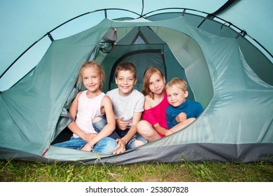 Children In A Tent. Camping. Happy Kids At Summer Vacations