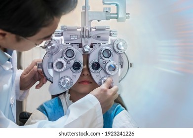 Children are tested with ophthalmology equipment by an optician. 
