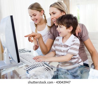 Children And Their Mother Using A Computer At Home