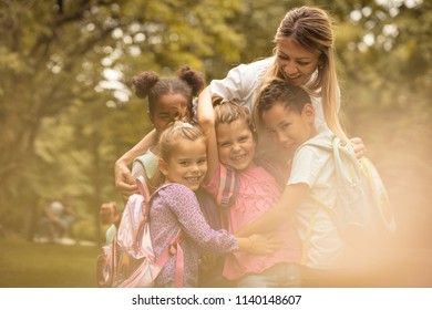Children with their children poses to camera  at nature. 