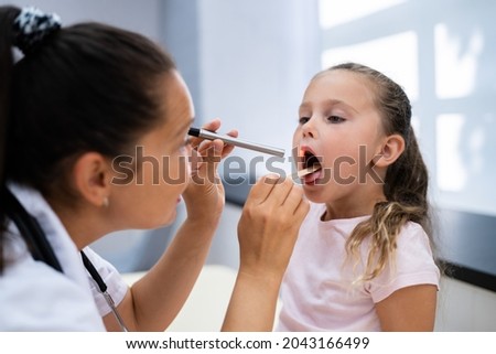 Children Throat Check For Flu. Doctor Checking Girl