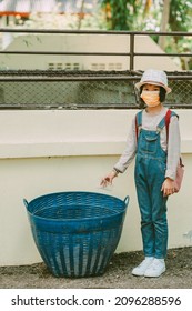 Children Throw Away Rubbish In Bin