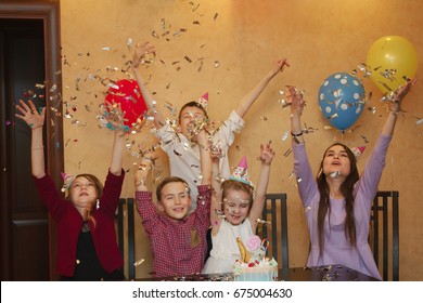 Children Throwing Confetti At A Children's Party. Kids Have Fun Together On A Family Holiday