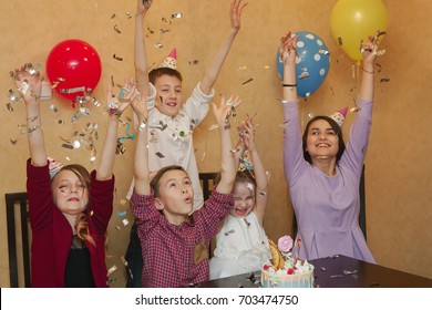 Children Throwing Confetti At A Children's Party. Kids Have Fun Together On A Family Holiday