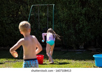 Children Throwing Water Balloons In Back Yard Water Fight 