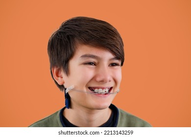 Children Tooth Care And Hygiene. Portrait Of A Teenager Boy With Diastema Overbite Teeth Missing Gap Wearing Orthodontic Appliance Treatment. Dental Braces With Child Concept.
