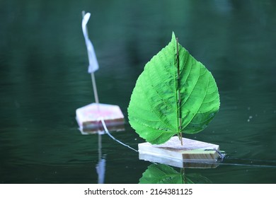 Children Toy Sailboat Wood And Leaf On The Water