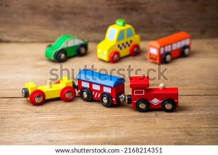children toy, train , cars, school bus, isolated on wooden background