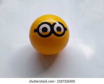 Children Toy Yellow Plastic Ball With Minion Character Top View On A White Background. Game Background Concept, Games, Playing, Hobbies, Hobbies, Lifestyle, Educational Toys, Action Figure, Gift