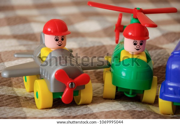 Children toys. Multi colored plastic constructor\
with blocks for building houses and cars, plain, bus with figures\
of people