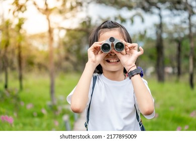 Children Travel And Holding Binoculars Looking On Green Nature Background, Asian Family Cute Child Playful For Learning Outdoors In Forest, Kids Journey In Beautiful Nature In Relaxing Time Of Summer 