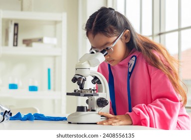 children using microscopes to study science at school