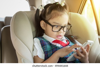 Children Using Mobile Smart Phone In Car