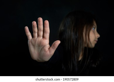 Children Violence. Girl With Her Hand Extended Signaling To Stop.