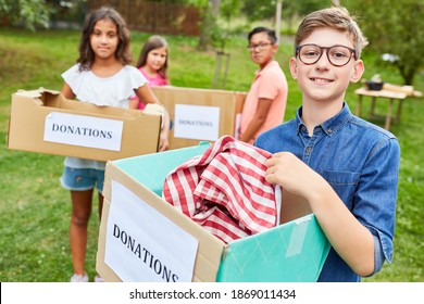 Children As Volunteers With Clothing Donation At A Fundraising Campaign