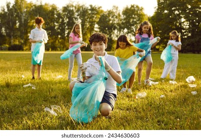 Children volunteers collect garbage to make the area a nice place at a social charity ecology event Happy little school kids clean park ground from human waste that people throw not reaching trash bin - Powered by Shutterstock