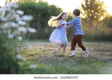 Children walk in the summer in nature. Child on a sunny spring morning in park. Traveling with children.