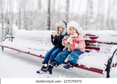 
Children Walk In The Winter Forest And Eat Ice Cream