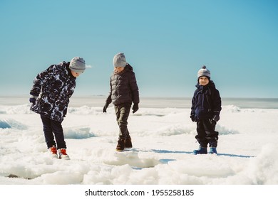 Children Walking On Ice Piling Of Finland Gulf. Image With Selective Focus