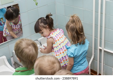 Children Wash Their Hands Before Eating In The Garden.