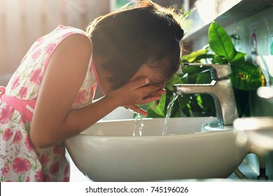 Children Washing Face In Basin