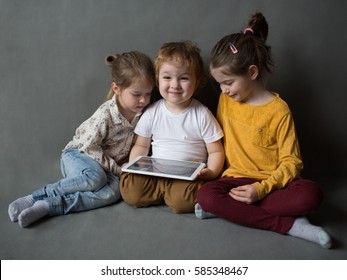 Children Watch Cartoons And Play On The  Tablet