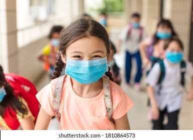 children wearing  face medical mask back to school after covid-19 quarantine - Shutterstock ID 1810864573