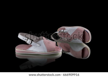 Children White and Pink Sandal on Black Background, Isolated Product, Top View, Studio.