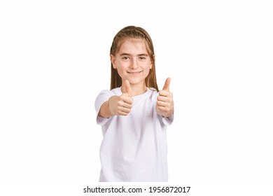 Children in white t-shirt. Studio isolated concept. Girl show thumb up. Approve gesture. Studio pretty portrait. Happy yes sign. Female person satisfied winner
