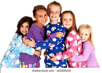 children in winter pajamas hugging each other