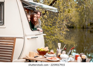 Children,family,brother sister traveling in camper,house on wheels. Trailer motor home.Looking in window. Funny road travel.Campsite van overnight.Wanderlust vacation,weekend.Girl,guy,happy adventure. - Shutterstock ID 2259017915