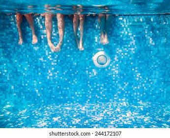 Children's and adults legs underwater in the swimming pool - Shutterstock ID 244172107