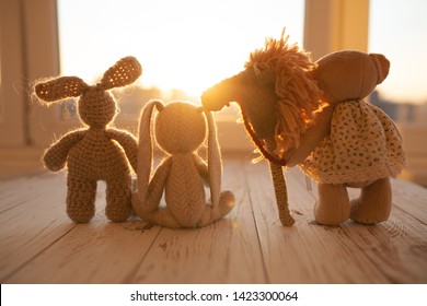 Children's animal stuffed toys bunny and teddy family on wooden floor in kids room. - Powered by Shutterstock