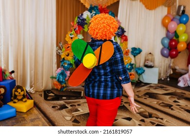 A Children's Animator In A Carlson Costume With A Propeller Indoors Entertains Children In A Kindergarten At A Birthday Party.